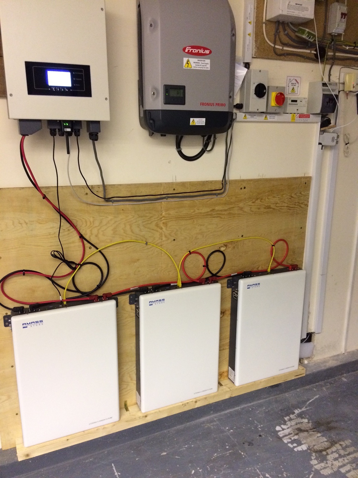 The solar inverter and the battery storage modules mounted on the wall